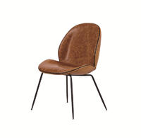 Shell shaped vintage leather dinning chair with metal legs